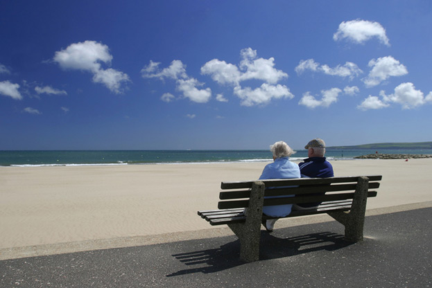 seniors on a bench at the beach