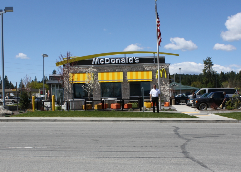 Tim Skubitz, in white, at his McDonalds in Newport, Wash., looks across the highway into Oldtown, Idaho. Photo: Jessica Robinson [KPLU]