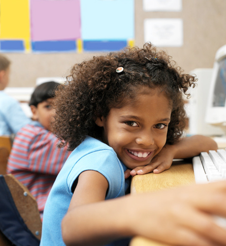 student smiling at computer