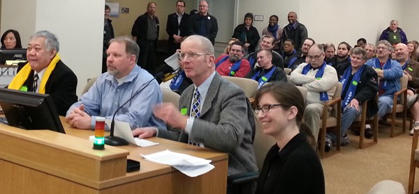 Vancouver small business owner and Main Street Alliance president Don Orange testifies for paid family and medical leave during a 2013 legislative committee hearing, with Frank Irigon of Puget Sound Alliance for Retirement Action, father Mark Barfield, and Sarah Francis of MomsRising.